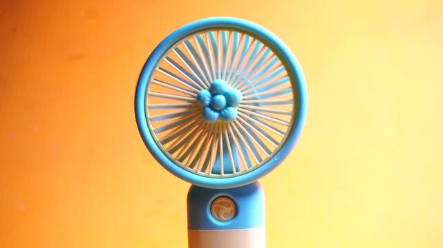 Compact handheld USB rechargeable mini fan providing portable cooling, quiet airflow, and convenient summer travel comfort.