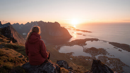 Fototapeta premium Woman hiking mountain sunset coastal landscape fjord sea woman back view red jacket silhouette peak ridge cliff viewpoint