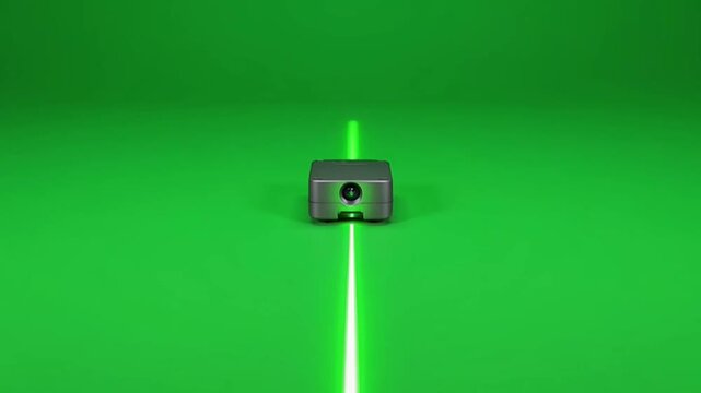 Green laser level tool projecting lines on green background.