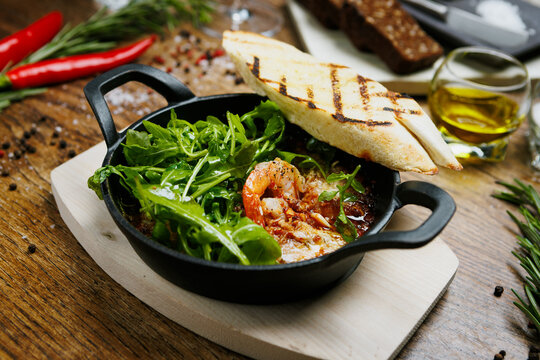 Traditional spanish tapas prawns with rocket and toasted bread