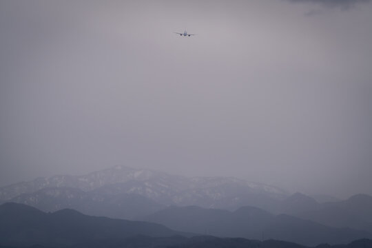 Airplane landing and take off at the airport in the city where we can see Japan alps background Toyama Japan 