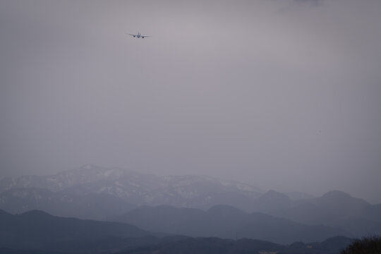 Airplane landing and take off at the airport in the city where we can see Japan alps background Toyama Japan 