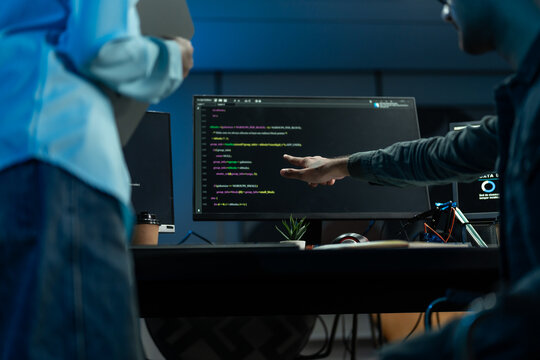 Developer Pointing At Program Code On Computer Screen