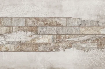 Abstract rustic ceramic tile texture with layered stone rectangles and earthy neutral tones on distressed background. © Vidal