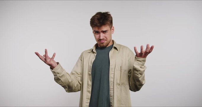 Man shows different reactions with hand gestures in indoor setting