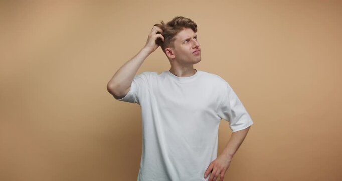 Man shows different expressions while thinking about a problem in a plain room