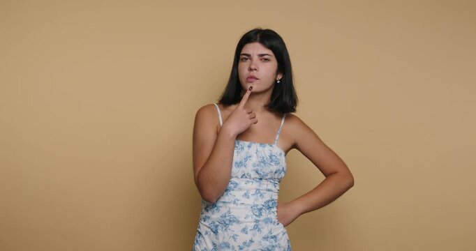 Woman thinks and poses in four different frames against a plain background in a basic studio setting