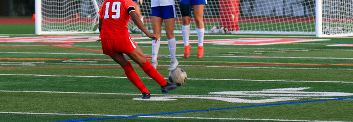 Soccer player in red uniform taking a penalty kick during a game © coachwood