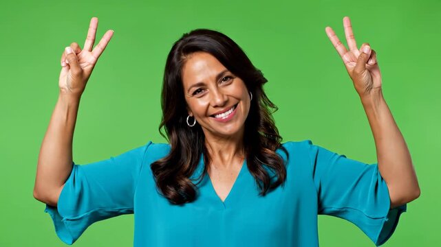 Happy woman gesturing peace sign isolated on green screen chroma key background female