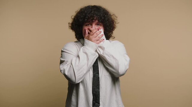 Person covers face in reactions in four frames showing different emotions in a simple setting