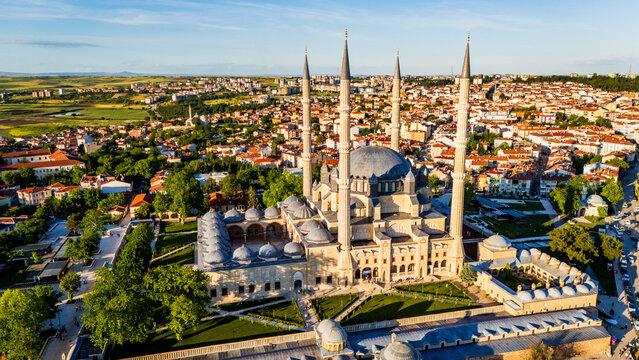 Selimiye Mosque in Edirne at sunset, showcasing Mimar Sinan imperial architecture with four high minarets, stone domes and the sprawling city background, Turkey