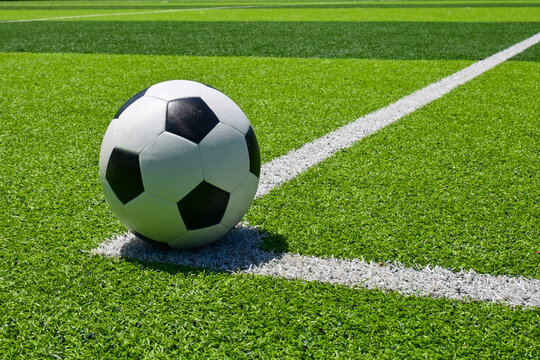 The football on the green soccer field
