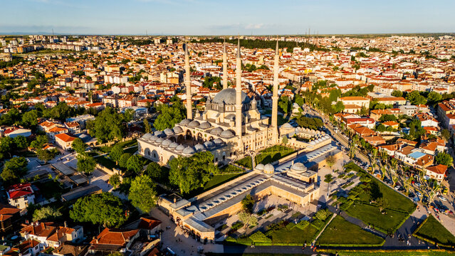 Selimiye Mosque in Edirne at sunset, showcasing Mimar Sinan imperial architecture with four high minarets, stone domes and the sprawling city background, Turkey