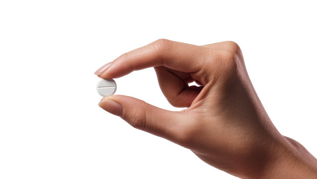 Fingers holding small white round pill with score line