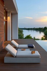 Fototapeta premium Contemporary waterfront terrace with paired sunbeds and infinity view for sunset banner and outdoor lifestyle design
