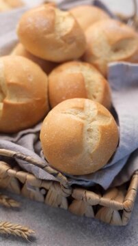 Freshly baked kaiser rolls in wicker basket
