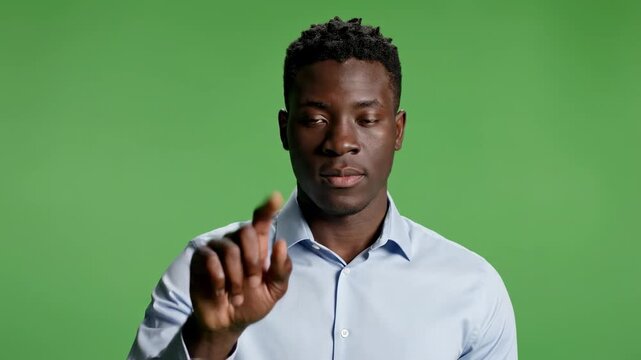 Man interacting with virtual touchscreen interface on green screen african american
