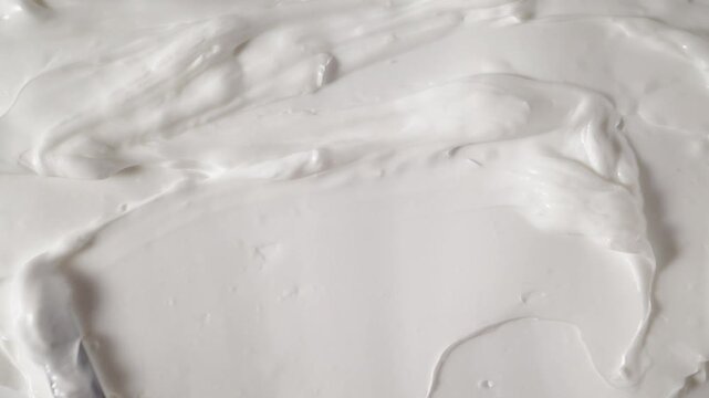 Sunscreen lotion texture smear top view. Detailed white sunblock or zinc cream being spread, demonstrating protective layer and high density texture of SPF product.