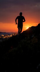 Fototapeta premium Male athlete jogging on rocky terrain during golden sunset with city lights glowing below, capturing outdoor fitness and endurance training at dusk.