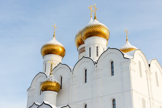 Golden domes of an Orthodox church under blue sky. The Cathedral of the Assumption in Yaroslavl is a prominent, rebuilt Orthodox church dating back to the 13th century