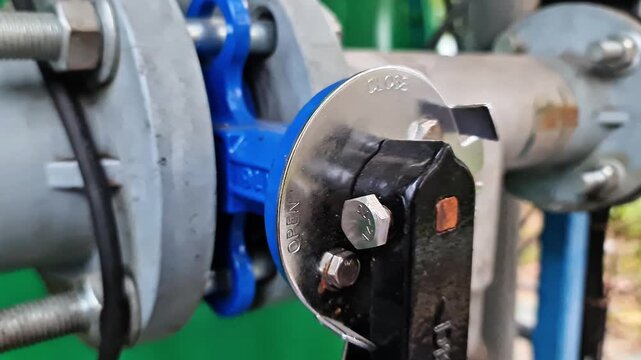 Sidoarjo, Indonesia - 2 June, 2026: Close up of industrial PVC piping system featuring manual butterfly valves with black levers for fluid flow control in a manufacturing plant
