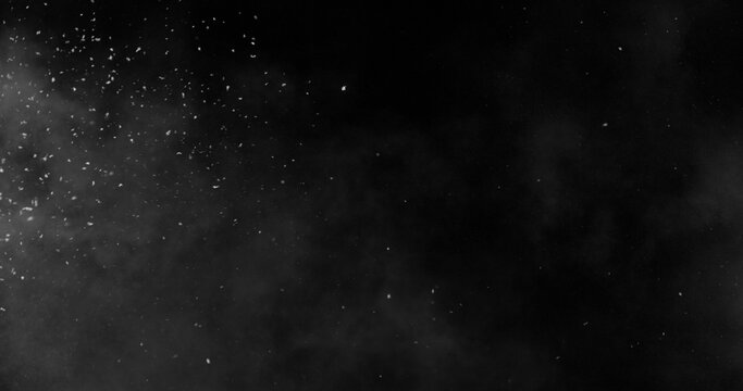 Realistic snowstorm particles and drifting snowflakes isolated on black background. Atmospheric winter weather effect ideal for overlays, visual effects, compositing and cinematic scenes.