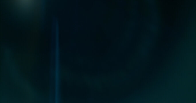Anamorphic lens flare and light leak effect on dark background. Minimal cinematic optical texture ideal for overlays, film production, motion graphics and visual effects.