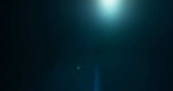 Anamorphic lens flare and light leak effect on dark background. Minimal cinematic optical texture ideal for overlays, film production, motion graphics and visual effects.