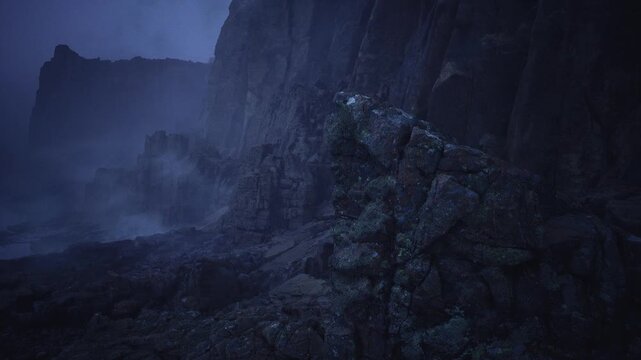 foggy rocky coastline under midnight blue, lonely basalt cliffs rising from dark surf with low mist, distant crumbling towers silhouette, cold ominous