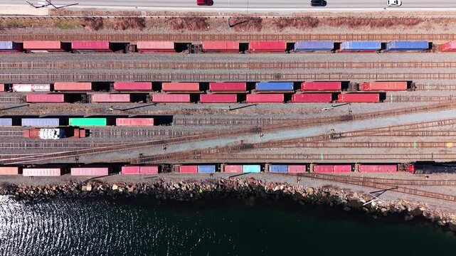 Aerial views reveal the vibrant patterns of cargo trains navigating Halifax's rail yard. Observe the busy infrastructure and the lively transportation of goods