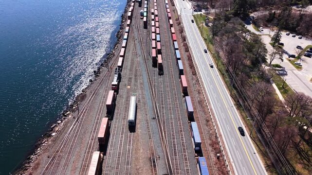 Explore the bustling railway in Halifax as cargo trains glide along the tracks by the waterfront. Experience the impressive infrastructure supporting industrial logistics