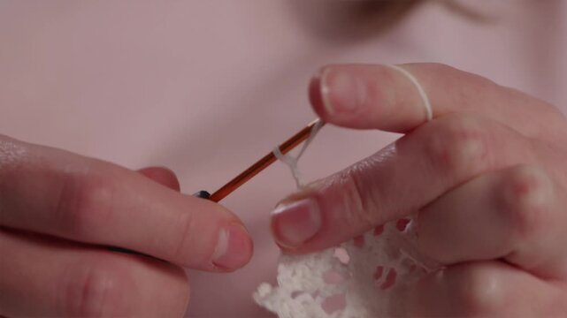 Close up of hands knitting a warm winter wool hat