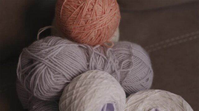 One bright yarn ball among neutral threads symbolic leadership concept