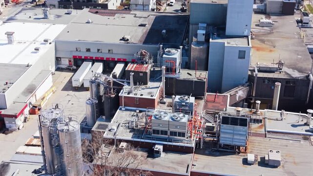 Fly over Labatt Brewing Co Ltd in Nova Scotia, Canada, and witness the intricate layout of this renowned brewery, bustling with activity and surrounded by industry