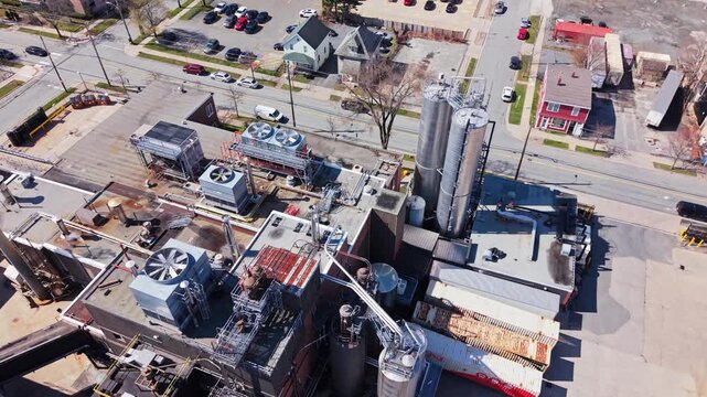 Experience an aerial journey over Labatt Brewing Co Ltd in Nova Scotia, revealing the intricate layout of the brewery and the bustling cityscape surrounding it