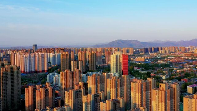 Dense Residential High-Rise Apartments at Sunset with Mountains