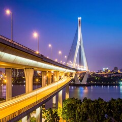 Naklejka premium Illuminated Curving Bridge Spanning River at Dusk in Modern City