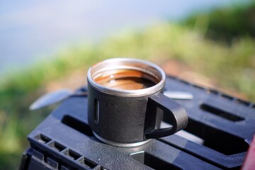 Hot Espresso Coffee in Travel Mug on Outdoor Table © dikadi16