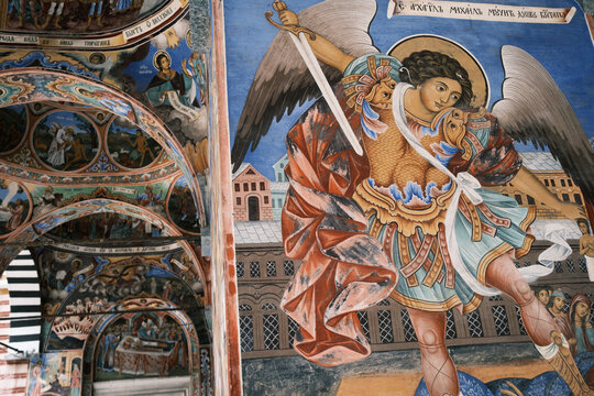 Close up of a majestic biblical fresco depicting Archangel Michael with a sword on the exterior veranda walls of the historic Eastern Orthodox Rila Monastery, UNESCO site, Bulgaria