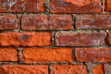Obraz premium Weathered red brick wall background texture with concrete mortar joints, construction material