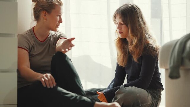 Mother having difficult conversation with teenage daughter
