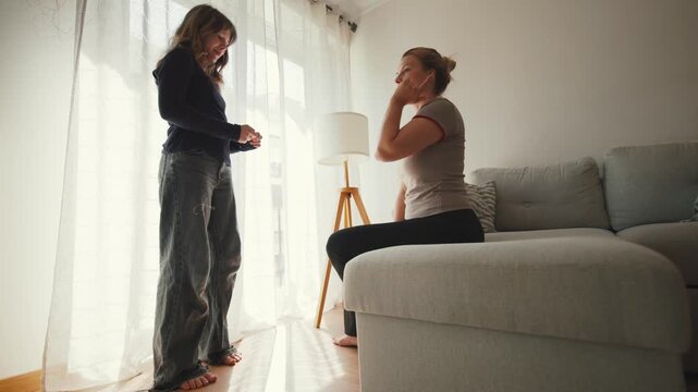 Young woman and mother having a difficult conversation at home