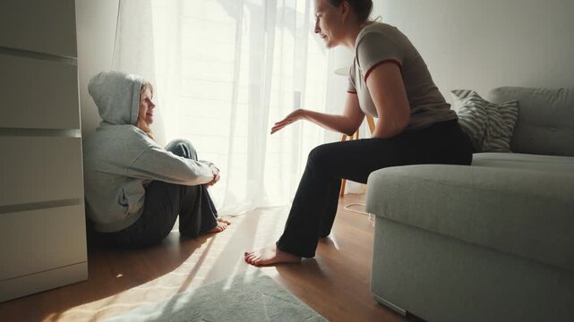 Mother scolding teenage daughter during difficult conversation