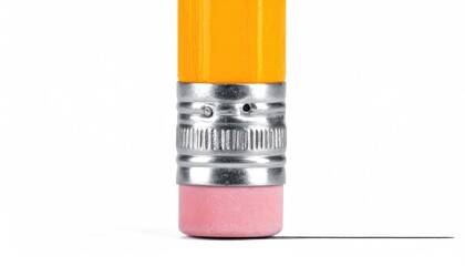 Obraz premium Close-up of a pencil eraser removing a thin line on a white surface