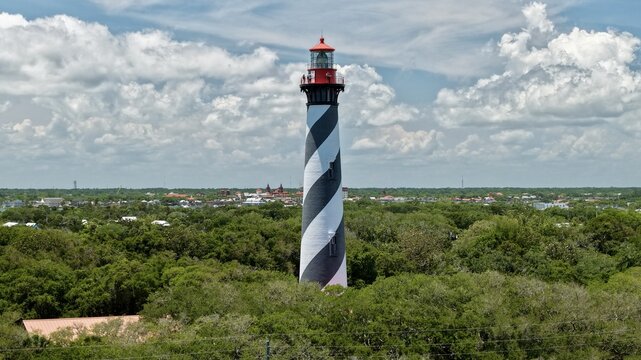 Aerial view of the St. Augustine Lighthouse with its iconic black and white spiral stripes on Anastasia Island in St. Johns County, Florida, United States.