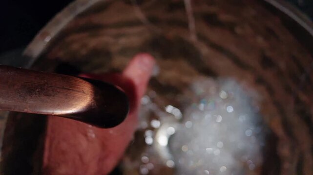 Person washing hands with soap under running water in close up cinematic footage.