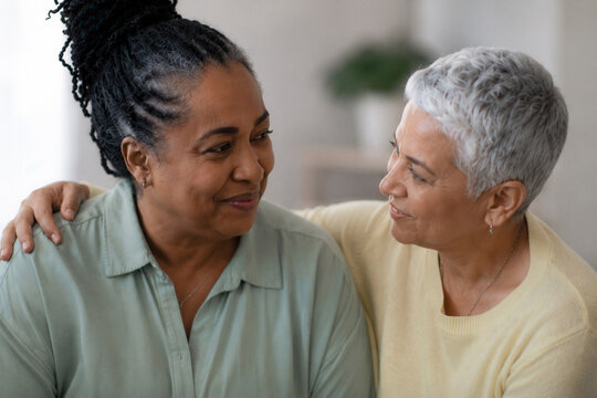 Two women share a warm, tender moment