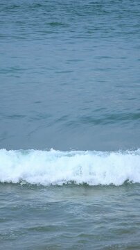 slow motion of the green glassy sea wave, surfing