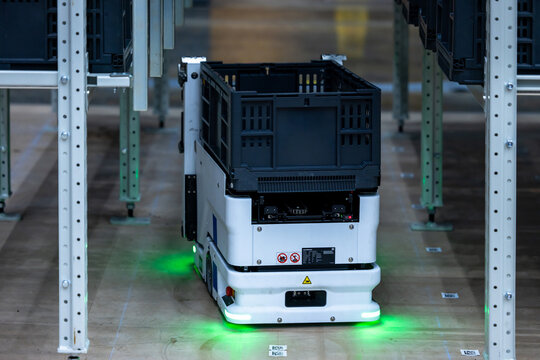 Autonomous mobile case handling robot scissor lift mechanism pick and retrieve plastic tote box from high shelves, Modern automated logistics warehouse smart technology, Robot handling plastic crates