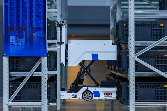 Autonomous mobile case handling robot scissor lift mechanism pick and retrieve plastic tote box from high shelves, Modern automated logistics warehouse smart technology, Robot handling plastic crates